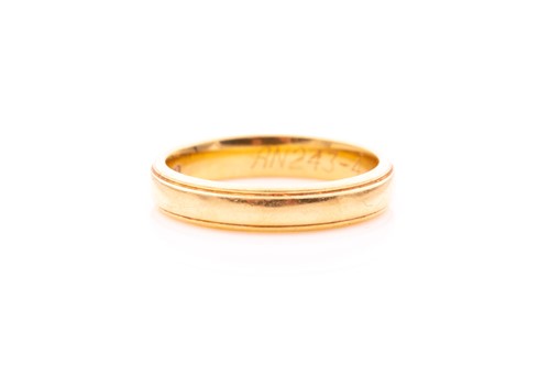 Lot 323 - An 18ct yellow gold wedding band, marked 750...