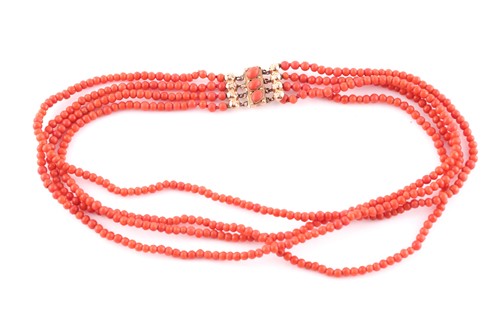 Lot 299 - A yellow metal and coral beaded necklace,...