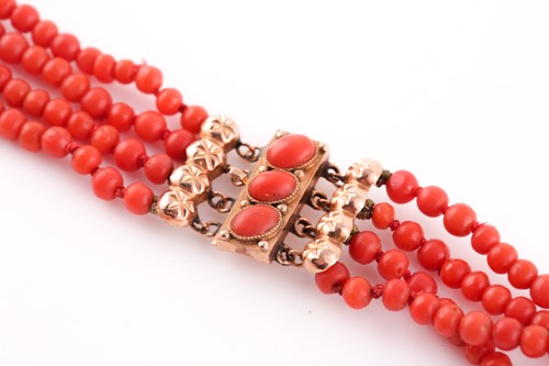 Lot 299 - A yellow metal and coral beaded necklace,...