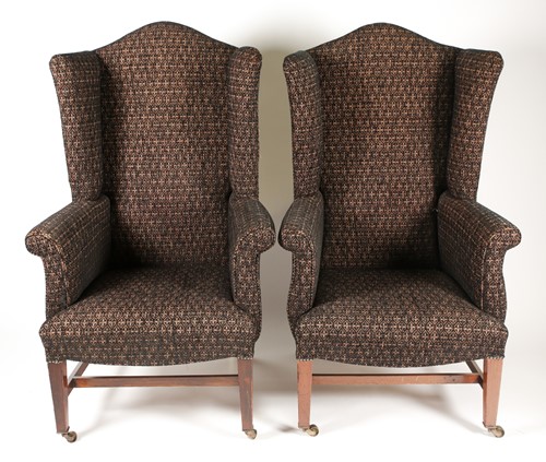 Lot 325 - A pair of George III style wingbacked fireside...