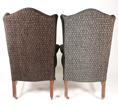 Lot 325 - A pair of George III style wingbacked fireside...