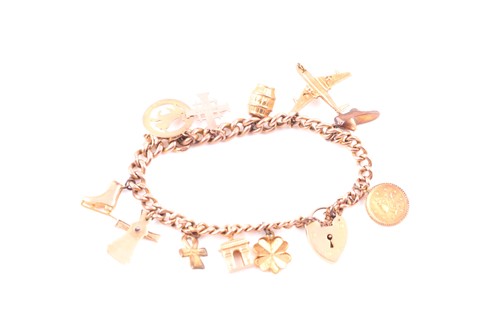 Lot 189 - A 9ct yellow gold charm bracelet, suspended...