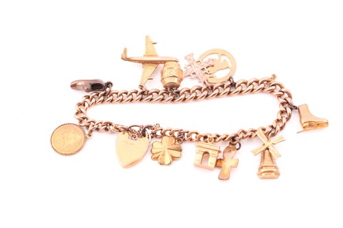 Lot 189 - A 9ct yellow gold charm bracelet, suspended...