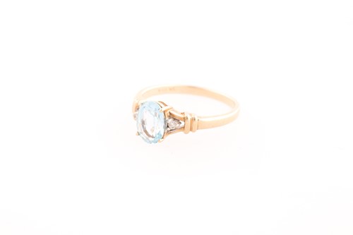 Lot 242 - A 9ct yellow gold, diamond, and blue topaz...