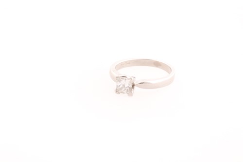 Lot 22 - A platinum and diamond ring, set with a square-...