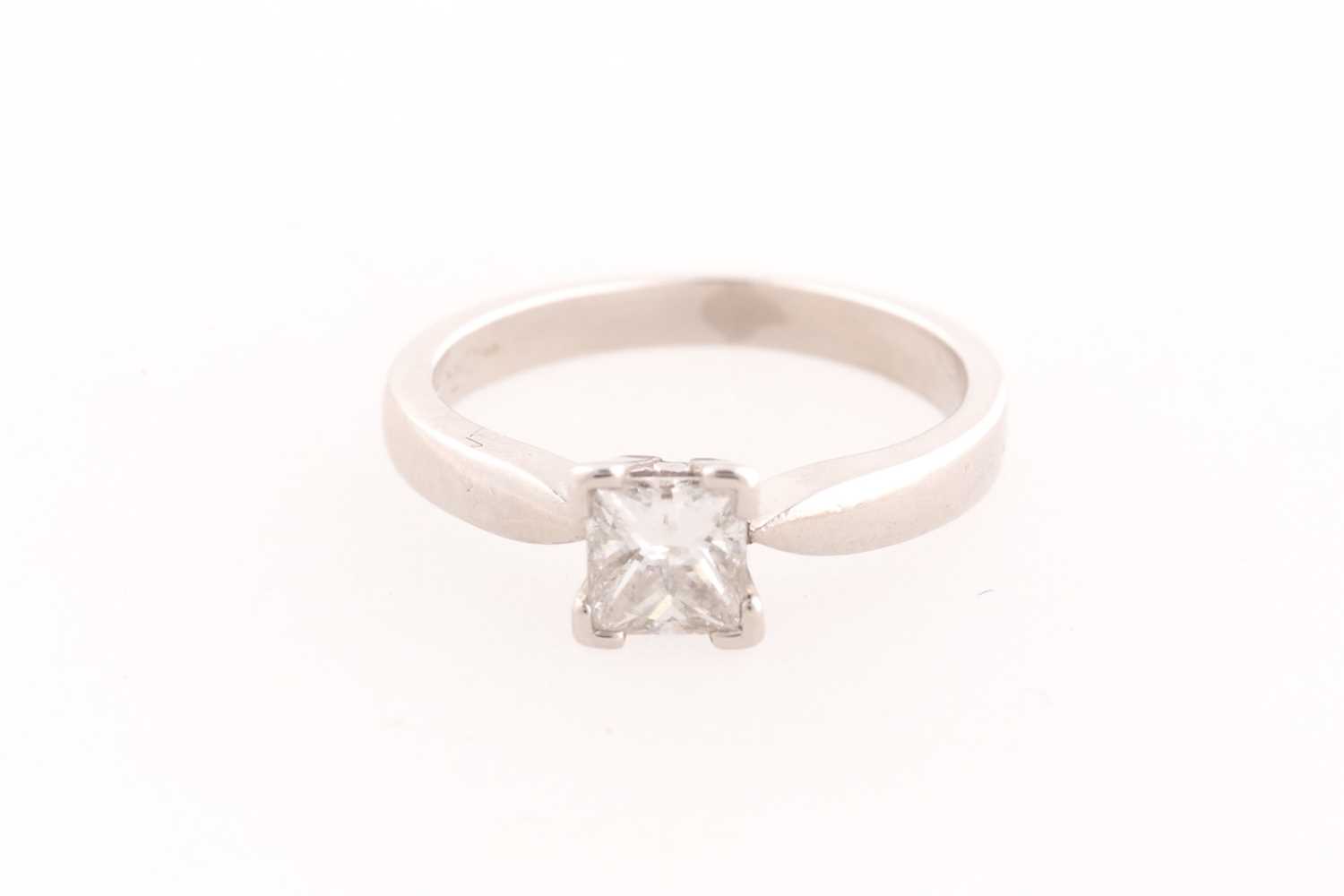 Lot 22 - A platinum and diamond ring, set with a square-...