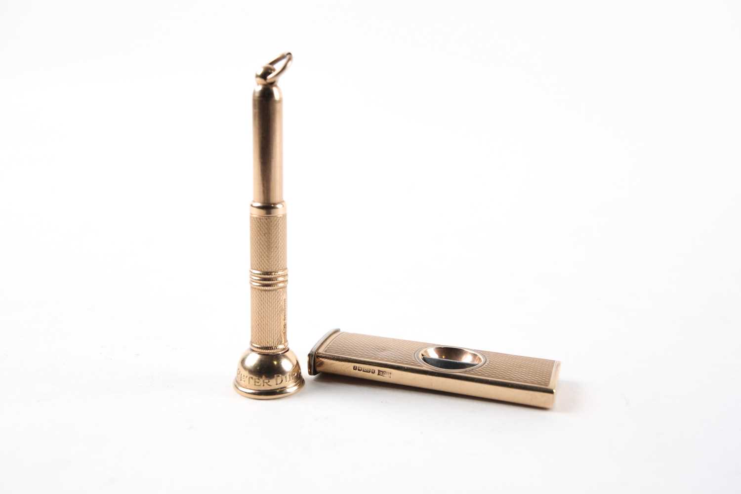Lot 4 - A 9 ct gold cigar cutter with engine turned...