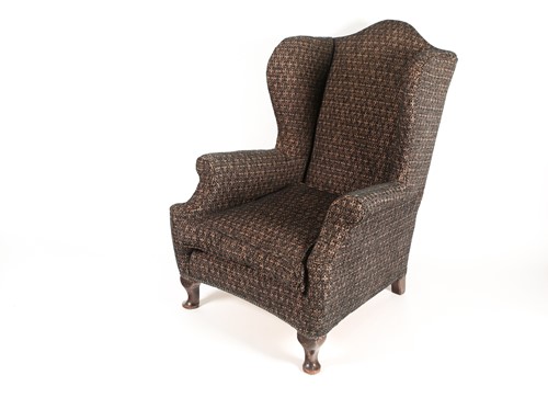 Lot 331 - An early 20th-century wing chair with rollover...