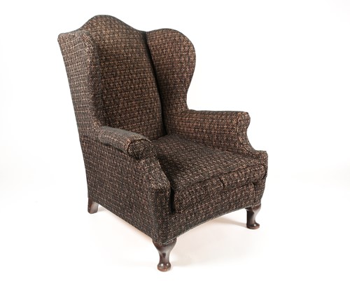 Lot 331 - An early 20th-century wing chair with rollover...