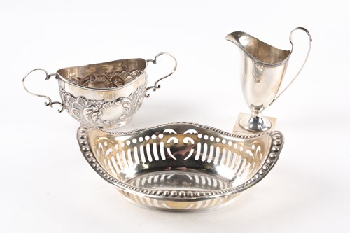 Lot 460 - A silver helmet shaped cream jug with loop...