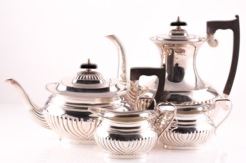 Lot 499 - A George III style silver four-piece tea and...