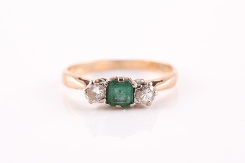 Lot 333 - A 9ct yellow gold, diamond, and emerald ring,...