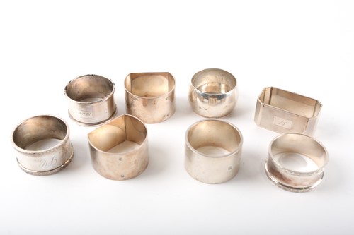 Lot 506 - A collection of eight silver napkin rings of...