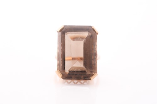 Lot 267 - A yellow metal and smoky quartz dress ring,...