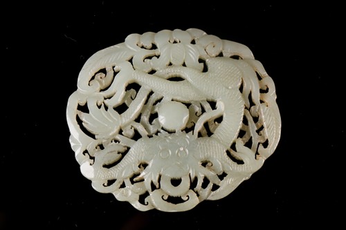 Lot 127 - A Chinese celadon jade plaque, carved with a...