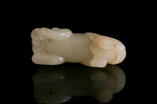 Lot 108 - A Chinese carved pale green jade figure of a...