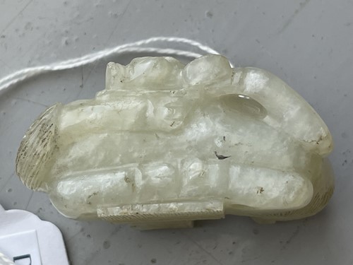 Lot 292 - A Chinese carved pale celadon green jade...