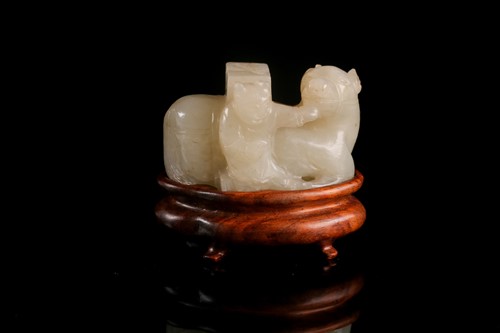 Lot 292 - A Chinese carved pale celadon green jade...