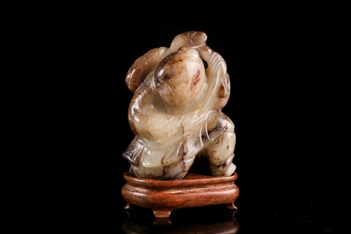 Lot 293 - A Chinese carved cream/ khaki green jade...
