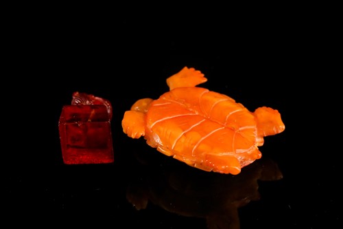Lot 147 - A Chinese carved butterscotch / yellow amber...