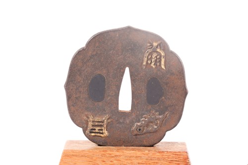 Lot 106 - A Japanese iron wood grain Tsuba, 19th century,...