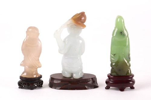 Lot 149 - A Chinese carved blue-green jade figure of a...
