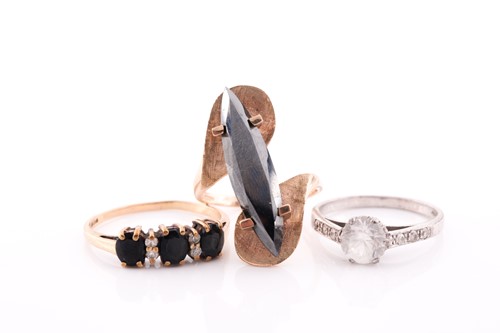Lot 310 - A 9ct yellow gold and black stone ring, set...