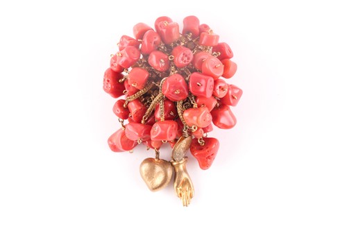 Lot 203 - A gilt metal and coral brooch, suspended with...