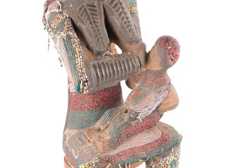 Lot 181 - An Igbo attributed beaded maternity seated...