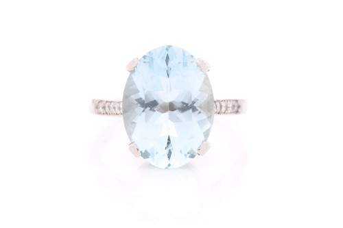 Lot 312 - A single stone aquamarine ring, the oval cut...