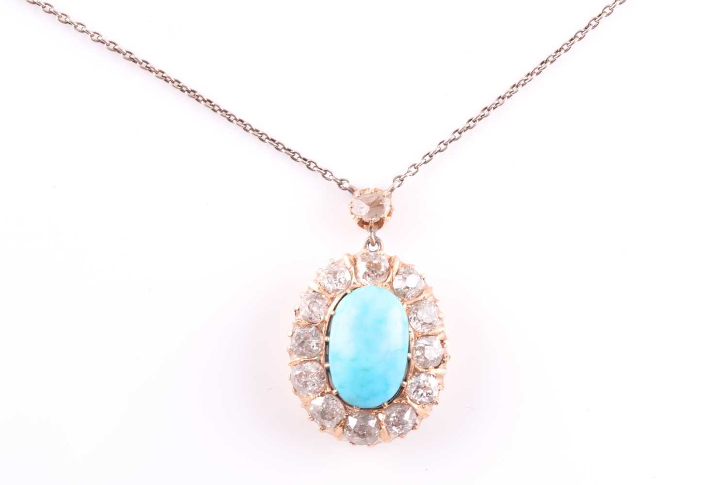 Lot 22 - A diamond and turquoise cluster pendant, set...