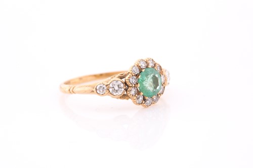 Lot 168 - An 18ct yellow gold, diamond, and emerald ring,...