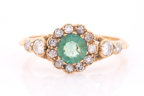 Lot 168 - An 18ct yellow gold, diamond, and emerald ring,...