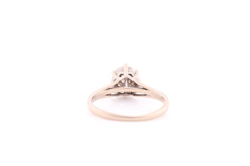 Lot 294 - A solitaire diamond ring, set with a round...