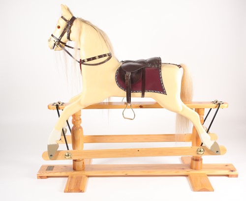 Lot 316 - A carved and painted cremello rocking horse...