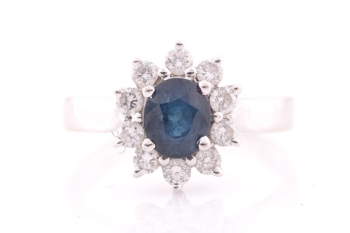 Lot 258 - An 18ct white gold, diamond, and sapphire ring,...