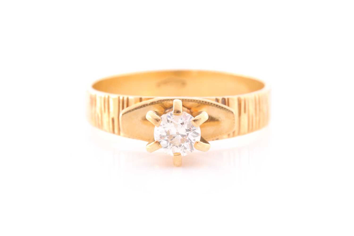 Lot 48 - An 18ct yellow gold and diamond ring, set with...