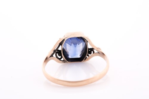 Lot 250 - A yellow metal and synthetic sapphire ring,...