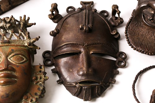 Lot 208 - An Ashanti bronze mask, Ghana, a bird either...