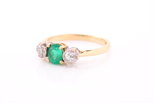 Lot 87 - A three stone half hoop emerald and diamond...