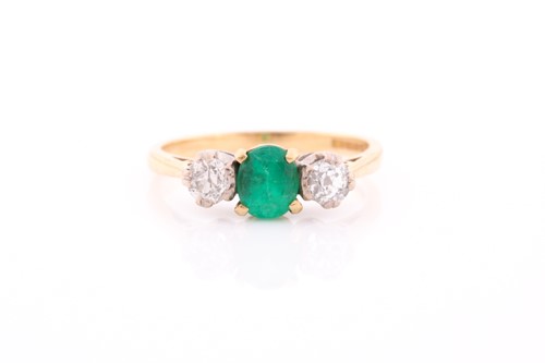 Lot 87 - A three stone half hoop emerald and diamond...