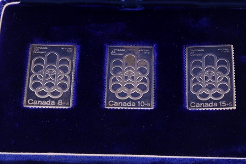 Lot 253 - A cased set of three silver ingots, designed...