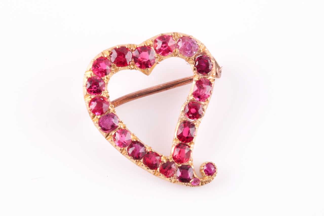 Lot 50 - A yellow metal and red spinel heart-shaped...