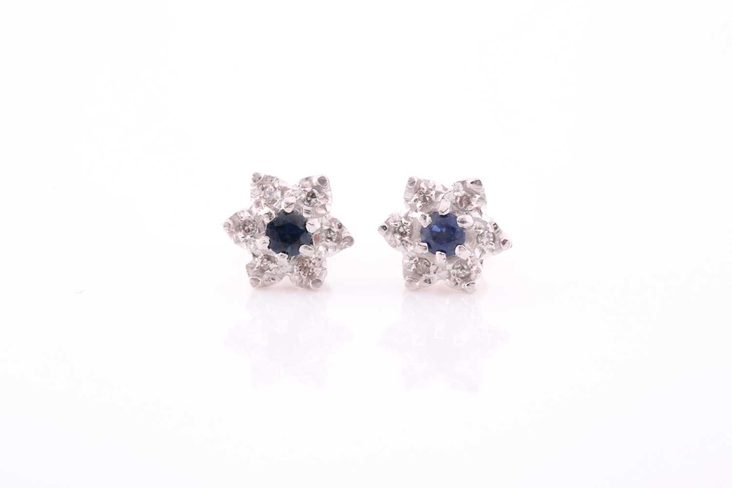 Lot 314 - A pair of diamond and sapphire floral cluster...