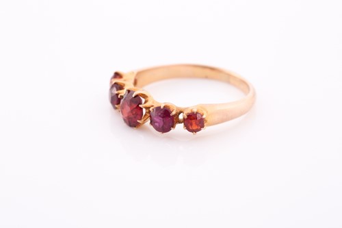 Lot 171 - A yellow metal and garnet ring, the five round-...