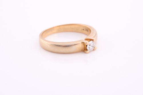Lot 157 - An 18ct yellow gold and diamond ring, claw-set...