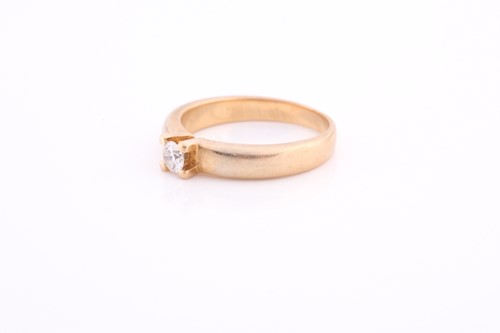 Lot 157 - An 18ct yellow gold and diamond ring, claw-set...