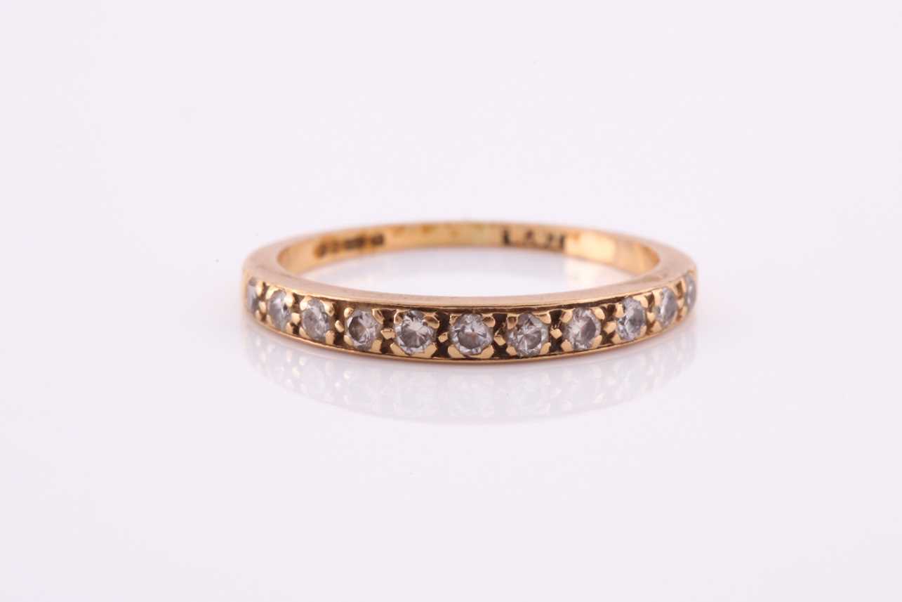 Lot 100 - An 18ct yellow gold band ring, pave-set with...