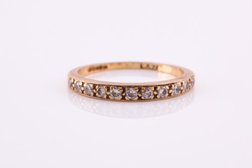 Lot 100A - An 18ct yellow gold band ring, pave-set with...
