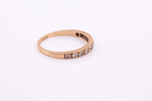 Lot 100 - An 18ct yellow gold band ring, pave-set with...